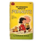 Front cover of the yellow vintage Crest paperback book "The Wonderful World of Peanuts" by Charles M. Schulz, featuring Lucy standing behind Charlie Brown while he pulls a wooden toy duck on wheels.