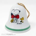 Snoopy wearing gift tag and bow with Woodstock Christmas Ornament Bell