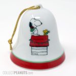 Snoopy & Woodstock exchanging gifts on doghouse Christmas Bell Ornament