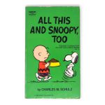 Front cover of the green vintage Fawcett Crest paperback book "All This and Snoopy, Too" by Charles M. Schulz, featuring Charlie Brown holding a dog food bowl while Snoopy dances eagerly in front of him.