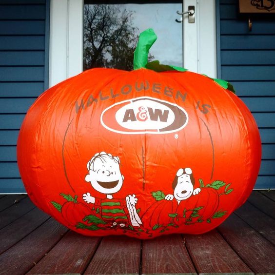 Large inflatable orange pumpkin featuring an A&W logo on the front, decorated with illustrations of Charlie Brown, Snoopy, and Woodstock.
