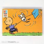Charlie Brown flying kite with Snoopy caught in string Puzzle