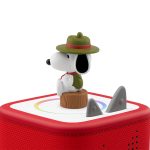 Snoopy Tonie figurine wearing a scout hat and scarf, sitting on a log atop a red Toniebox audio player.