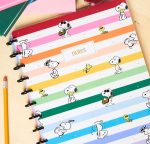 Snoopy daily planner featuring pastel horizontal stripes and various illustrations of Snoopy and Woodstock.