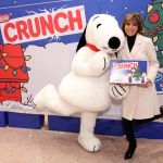 Lisa Rinna poses against a festive backdrop with Snoopy at the NESTLE CRUNCH PEANUTS launch at IT'SUGAR inside Universal CityWalk on Tuesday, Dec. 2, 2014 in Los Angeles. NESTLE CRUNCH and PEANUTS have partnered on a limited edition holiday chocolate collection featuring classic PEANUTS scenes on the packaging. (Photo by Casey Rodgers/Invision for NESTLE CRUNCH/AP Images) CRUNCH and PEANUTS Holiday Launch