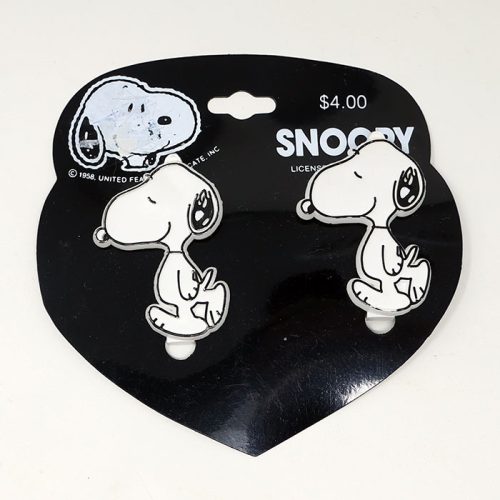 Two vintage Snoopy hair barrettes attached to a black heart-shaped display card with white Snoopy text and a $4.00 price tag.