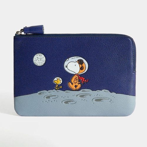 Astronaut Snoopy Anya Hindmarch leather coin purse featuring a dark blue night sky with a white moon above a lighter blue lunar surface, where an embroidered Snoopy in an astronaut helmet and a yellow Woodstock look out at the craters