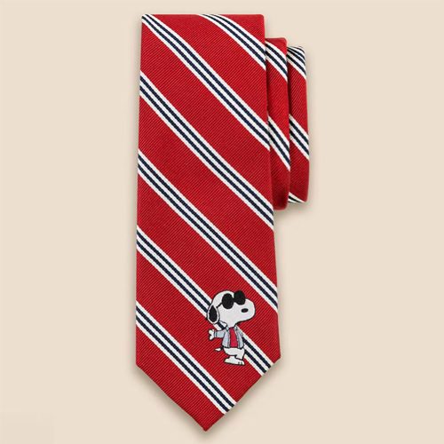 A red and blue striped Brooks Brothers necktie featuring a small embroidered graphic of Snoopy walking in a red jacket and white scarf near the bottom.